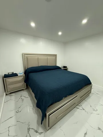 a bedroom with a bed and a couch