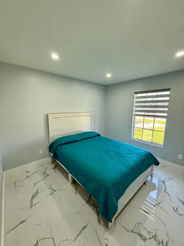 a bed sitting in a room next to a window