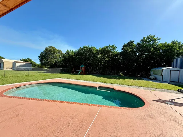 a view of swimming pool with a yard