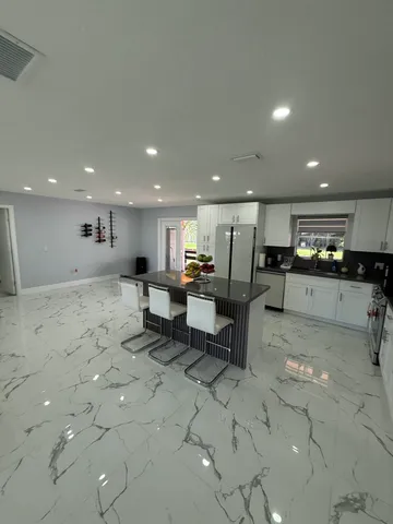 a large kitchen with lots of counter space and windows