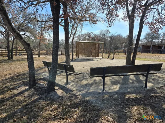 a view of a bench in a backyard