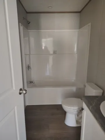 a bathroom with a toilet and a shower