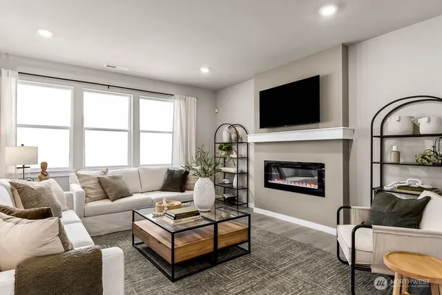 a living room with furniture a fireplace and a flat screen tv