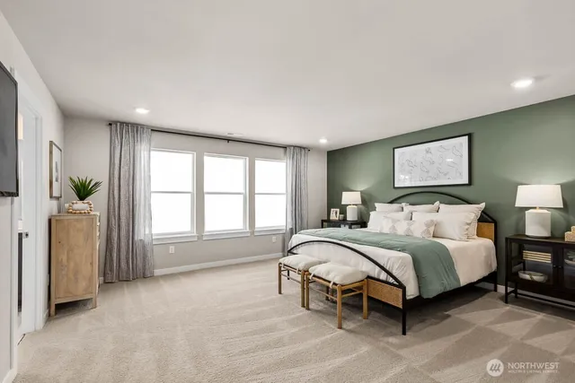 a spacious bedroom with a bed and a large window