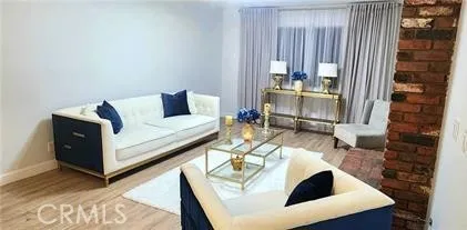 a living room with furniture and a painting on the wall