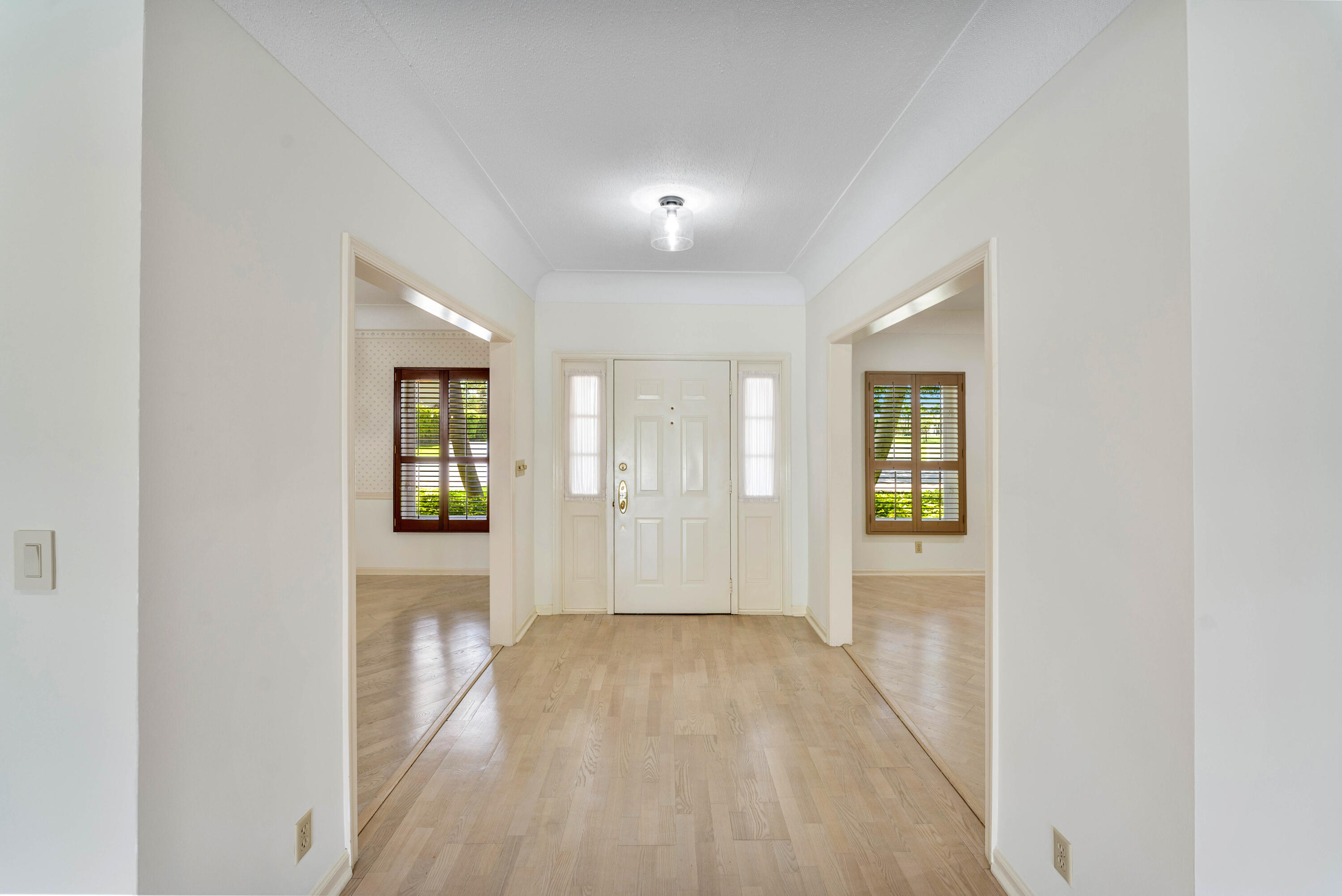 1851 Thatch Palm Drive Boca Raton, FL 33432 - Photo 7 of 70 wooden floor in an empty room with a window