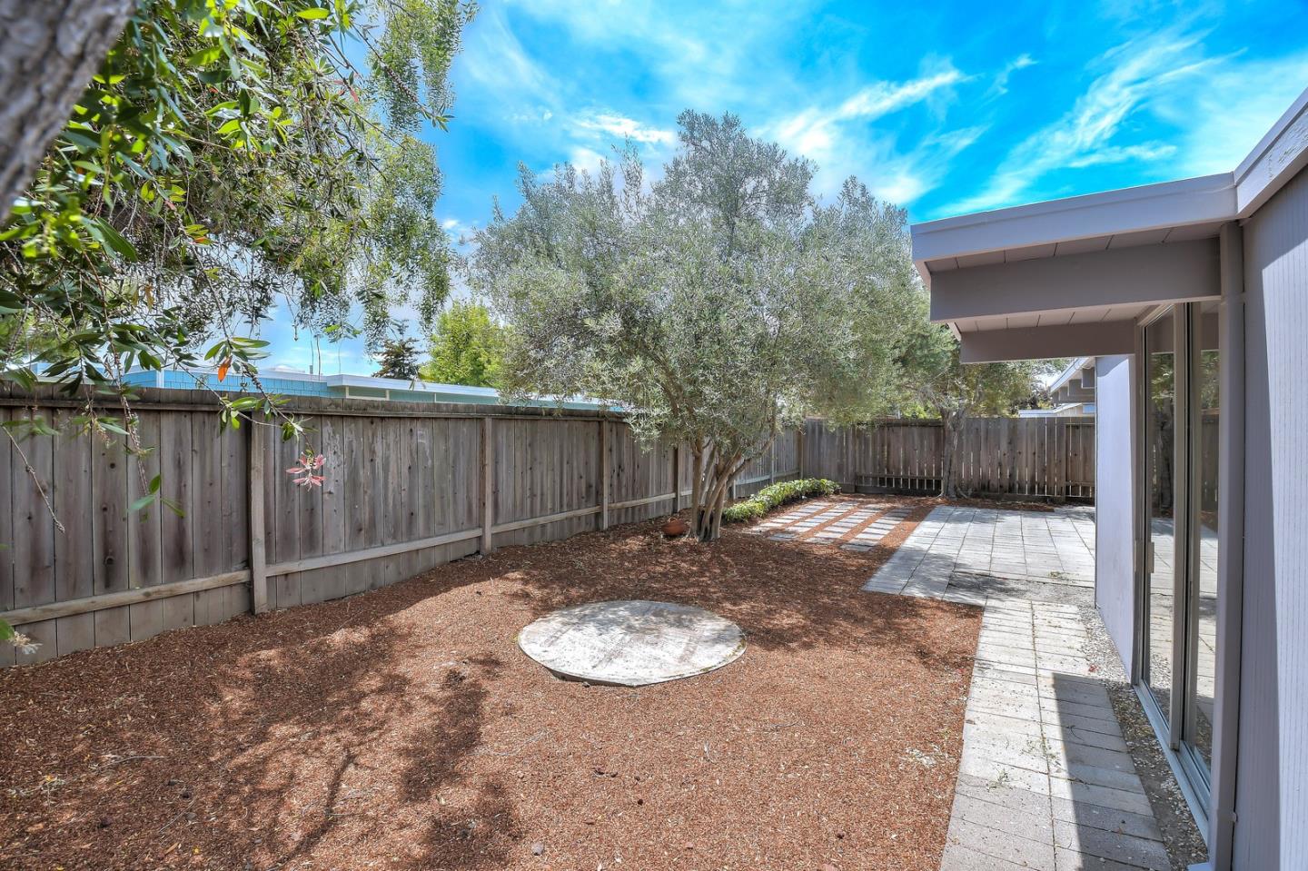 834 Constitution Drive Foster City, CA 94404 - Photo 32 of 34 a view of a backyard with large tree and wooden fence
