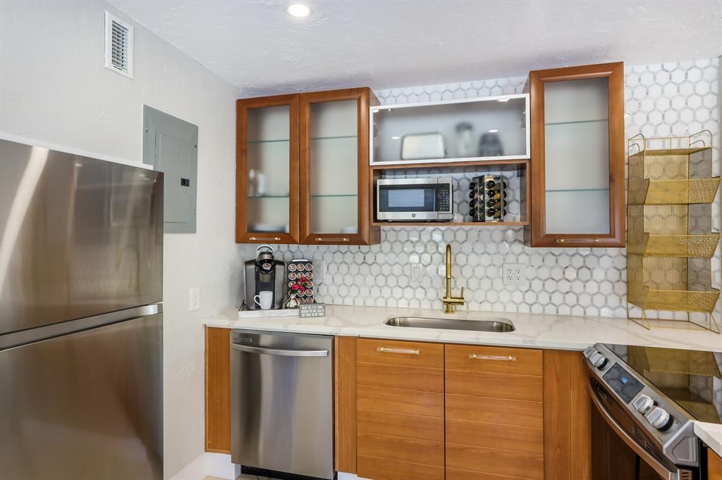 161 Golden Gate Point, Unit 1 Sarasota, FL 34236 - Photo 20 of 79 a kitchen with stainless steel appliances granite countertop a refrigerator and a sink