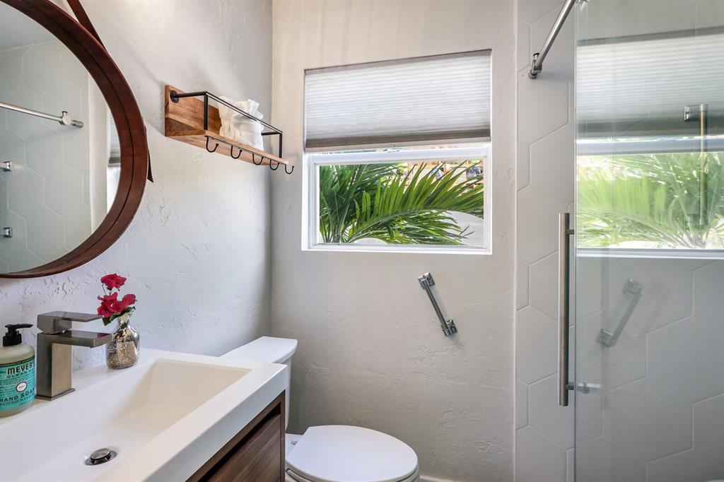 161 Golden Gate Point, Unit 1 Sarasota, FL 34236 - Photo 22 of 79 a bathroom with a sink toilet and a mirror