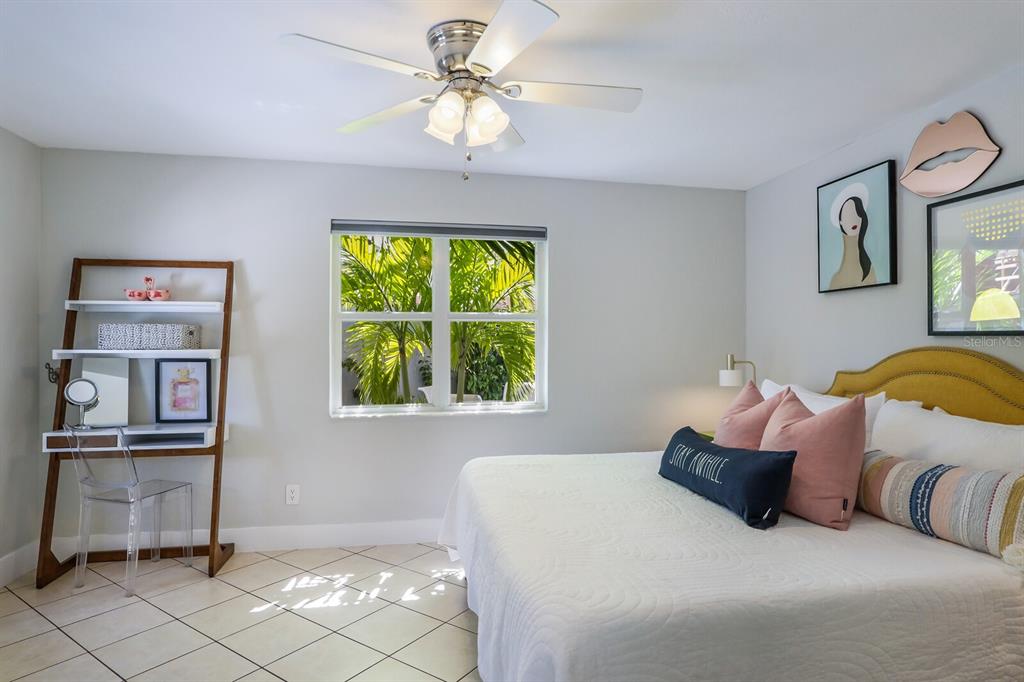 161 Golden Gate Point, Unit 1 Sarasota, FL 34236 - Photo 24 of 79 a bedroom with a bed and a chandelier
