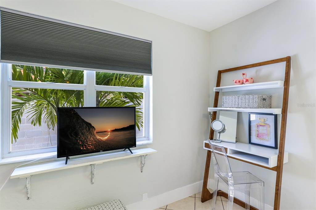 161 Golden Gate Point, Unit 1 Sarasota, FL 34236 - Photo 25 of 79 a living room with a bed and a dresser