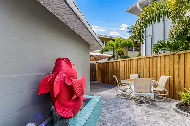 a backyard of a house with table and chairs