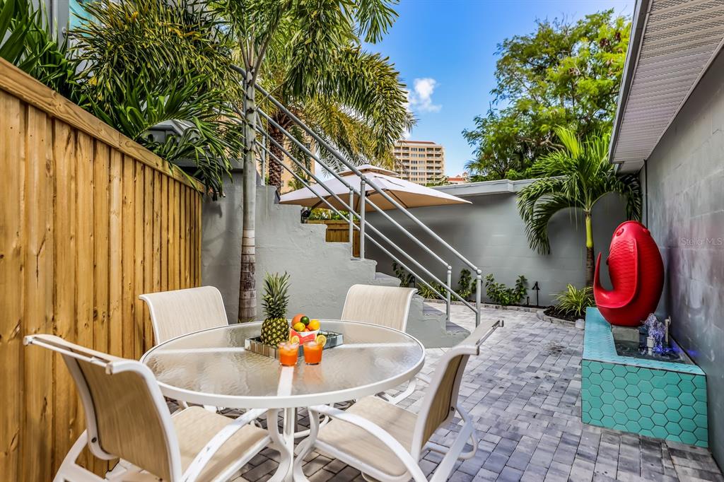 161 Golden Gate Point, Unit 1 Sarasota, FL 34236 - Photo 33 of 79 a backyard of a house with table and chairs