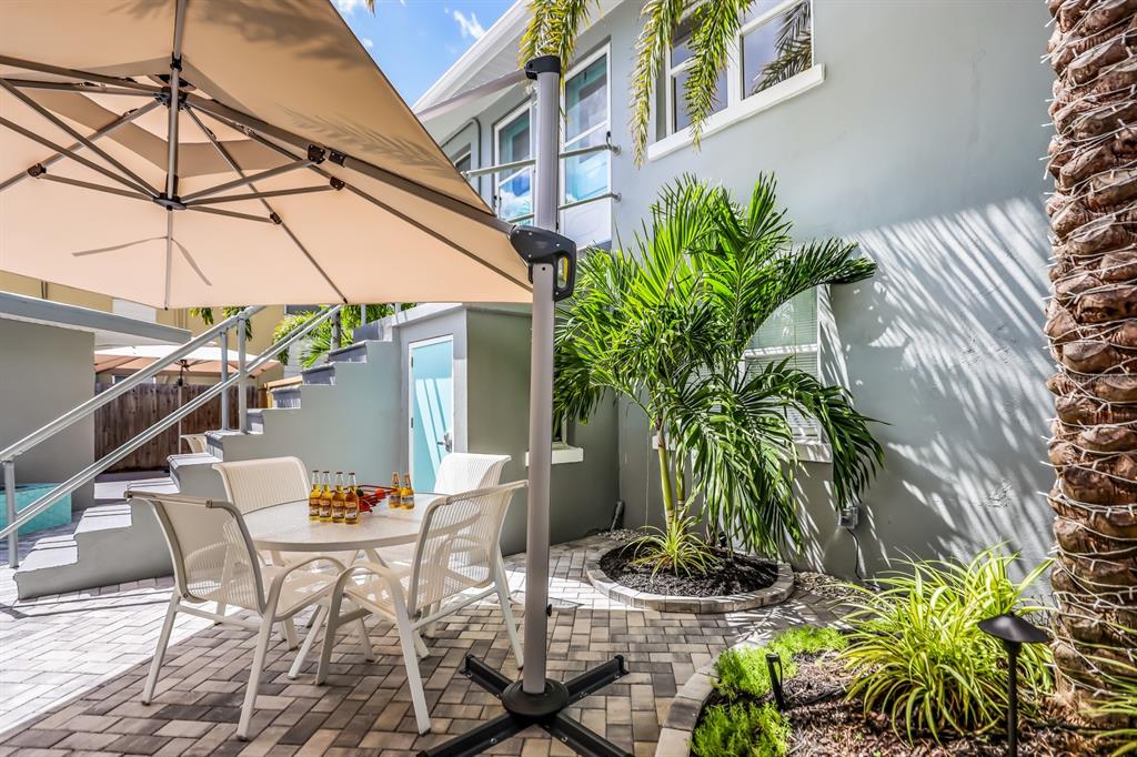 161 Golden Gate Point, Unit 1 Sarasota, FL 34236 - Photo 53 of 79 a view of a chairs and table in a backyard
