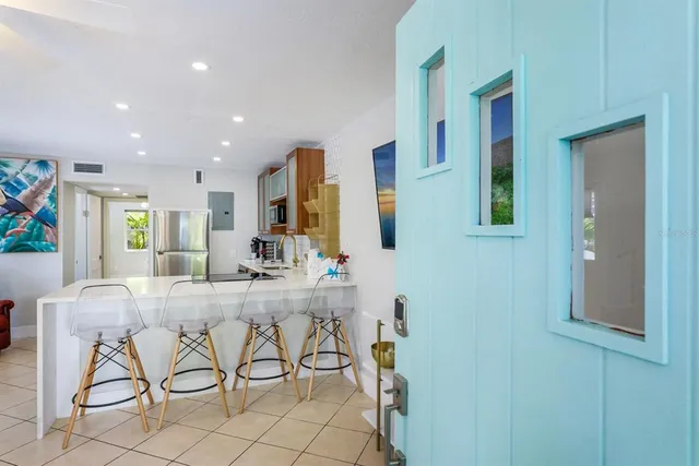 a view of a room with table and chairs