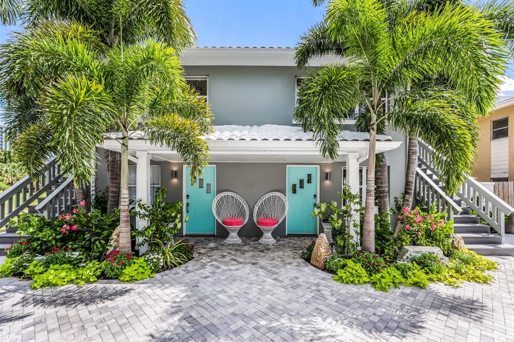 161 Golden Gate Point, Unit 1 Sarasota, FL 34236 - Photo 10 of 79 a view of a house with potted plants and a flower garden
