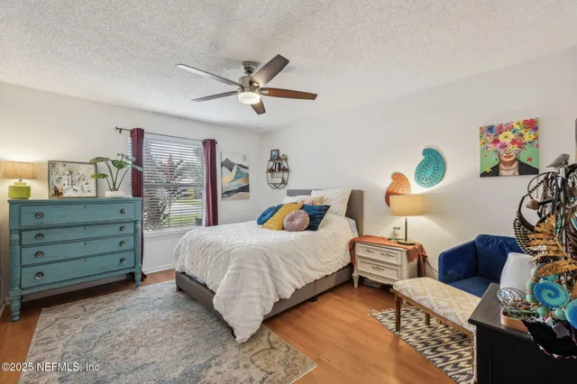a spacious bedroom with a bed and a chandelier