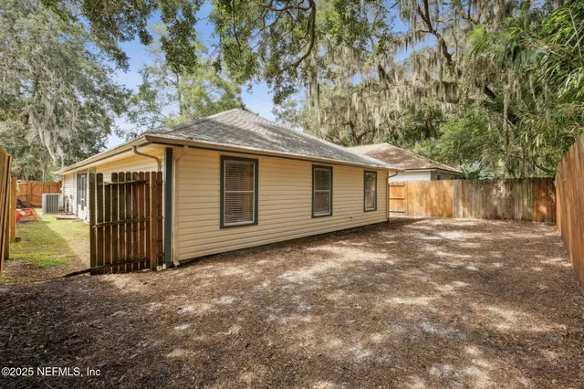 a backyard of a house with a tree