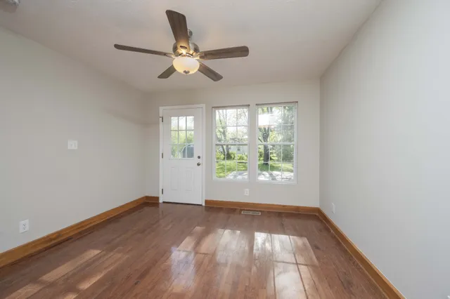 wooden floor in an empty room with a window