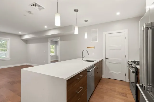 a kitchen with a sink a counter space and appliances