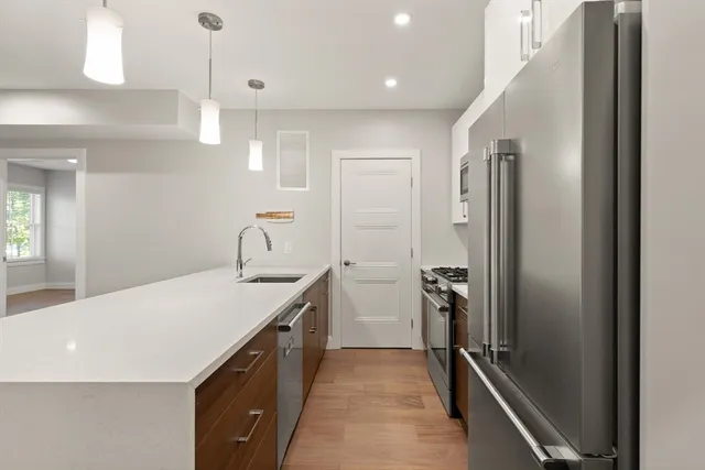 a kitchen with a sink appliances and cabinets
