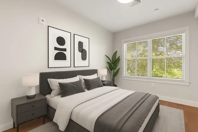 a bedroom with a bed and a window