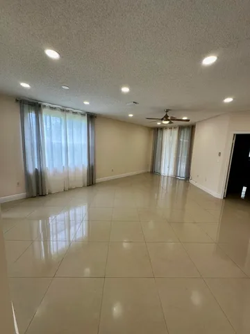 a view of a hall with wooden cabinet