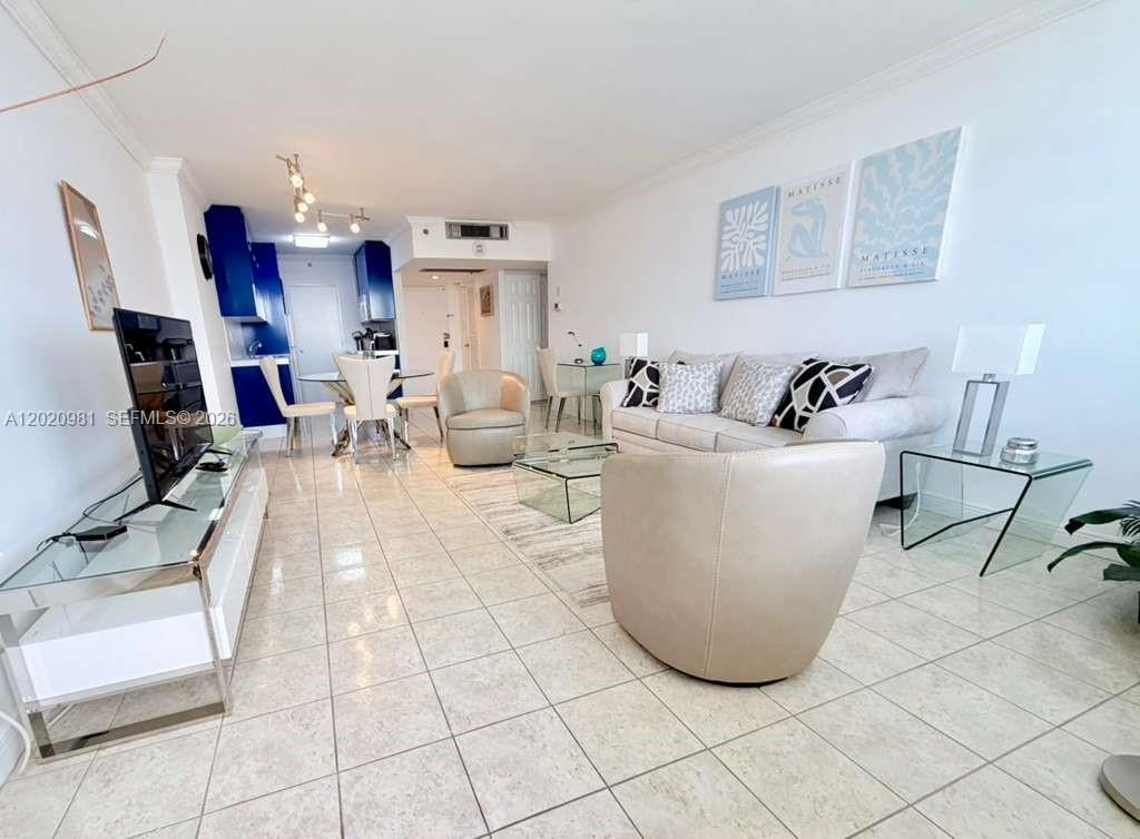 100 Lincoln Road, Unit 1423 Miami Beach, FL 33139 - Photo 5 of 17 a living room with furniture and a dining table