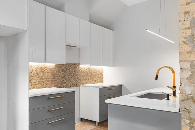 a kitchen with stainless steel appliances granite countertop a sink and a stove