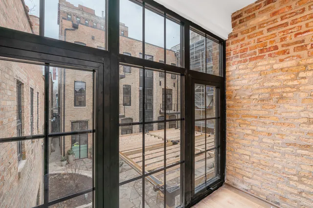a view of empty room with wooden floor and fireplace