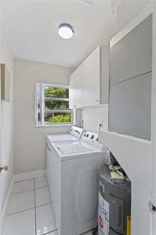 a utility room with sink washer and dryer