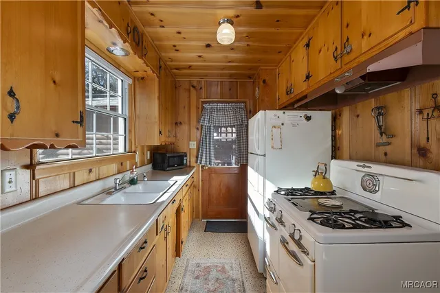 a large white kitchen with a large window