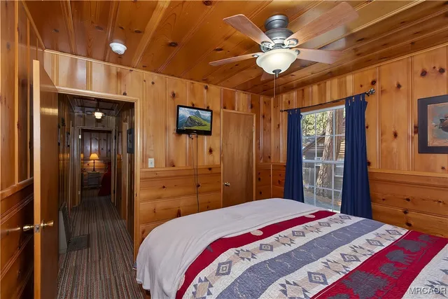 a bedroom with a large bed and a chandelier