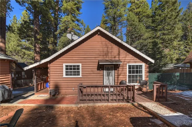a view of a patio with table and chairs with wooden fence and plants