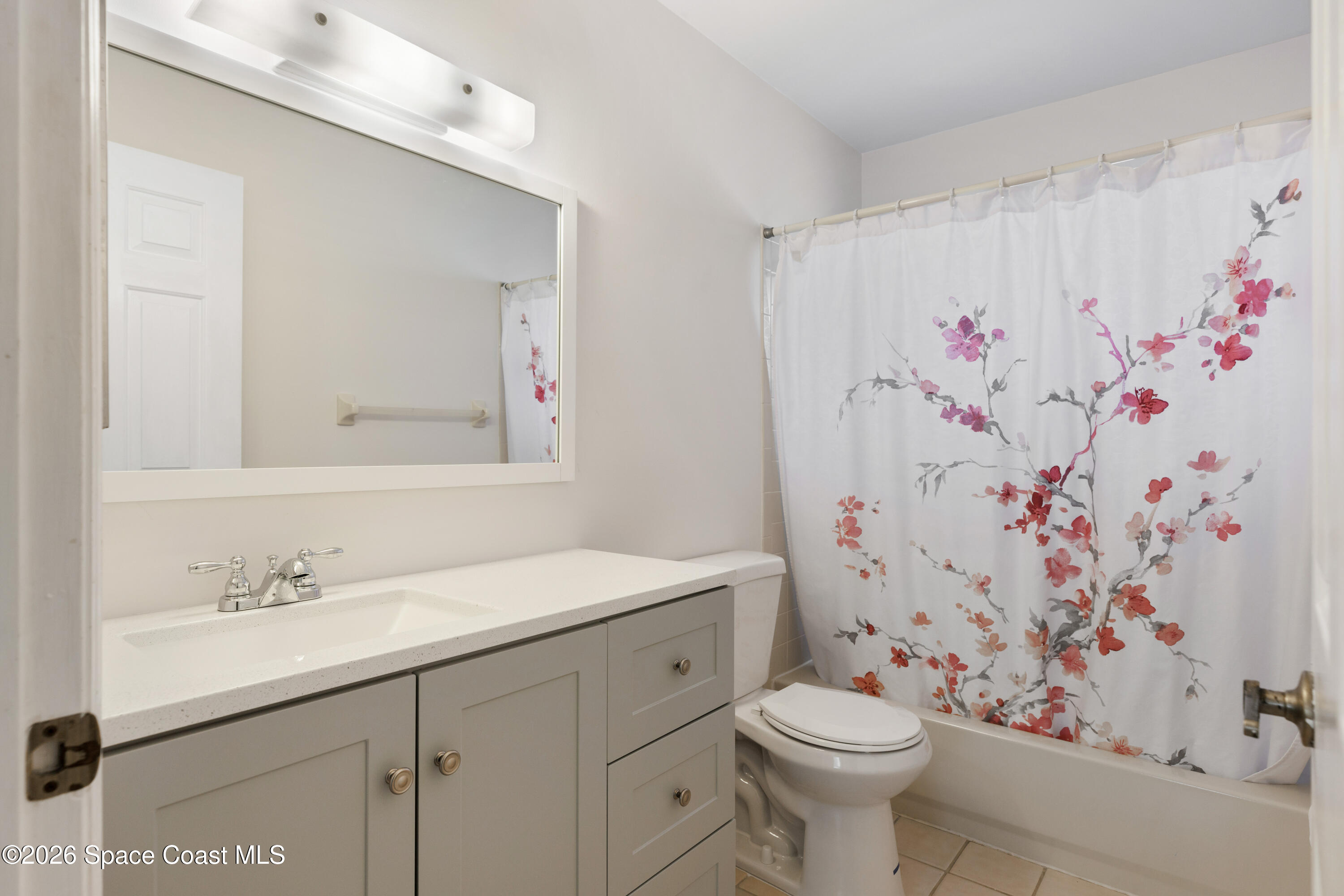 654 Centre Court Southwest, Unit 201 Vero Beach, FL 32962 - Photo 12 of 20 a bathroom with a sink and a toilet