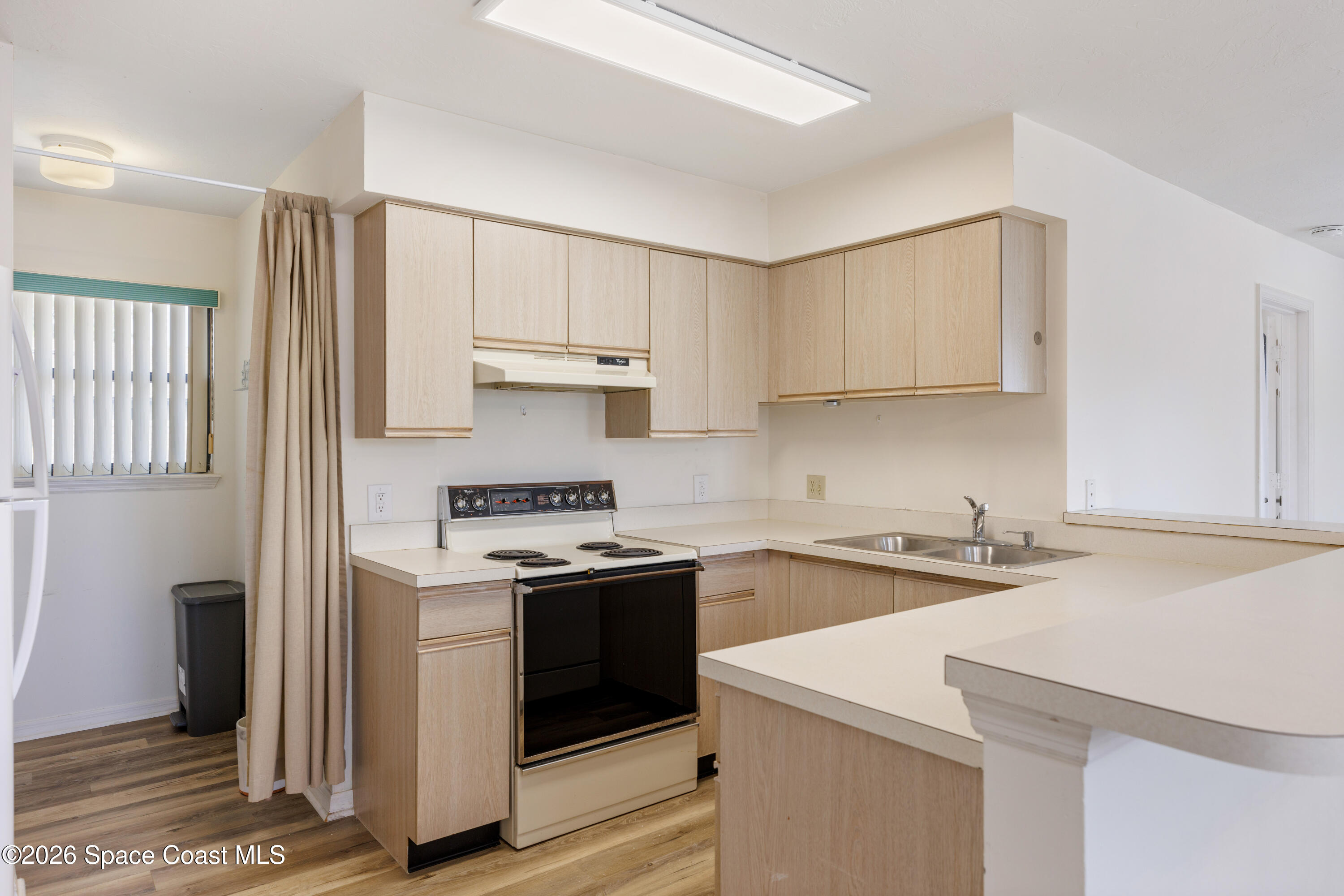 654 Centre Court Southwest, Unit 201 Vero Beach, FL 32962 - Photo 13 of 20 a kitchen with stainless steel appliances a sink stove and refrigerator