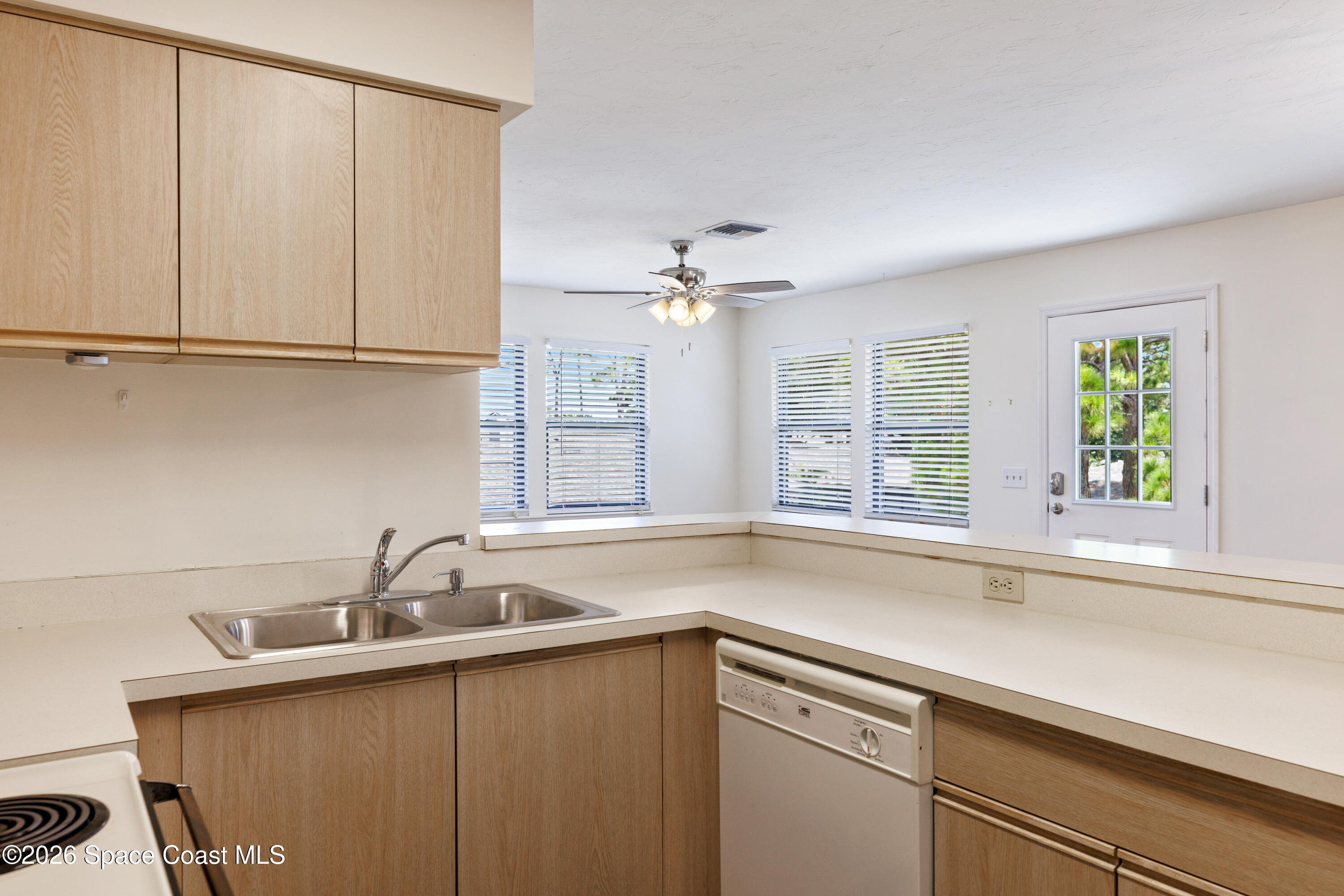 654 Centre Court Southwest, Unit 201 Vero Beach, FL 32962 - Photo 14 of 20 a kitchen with a sink and cabinets