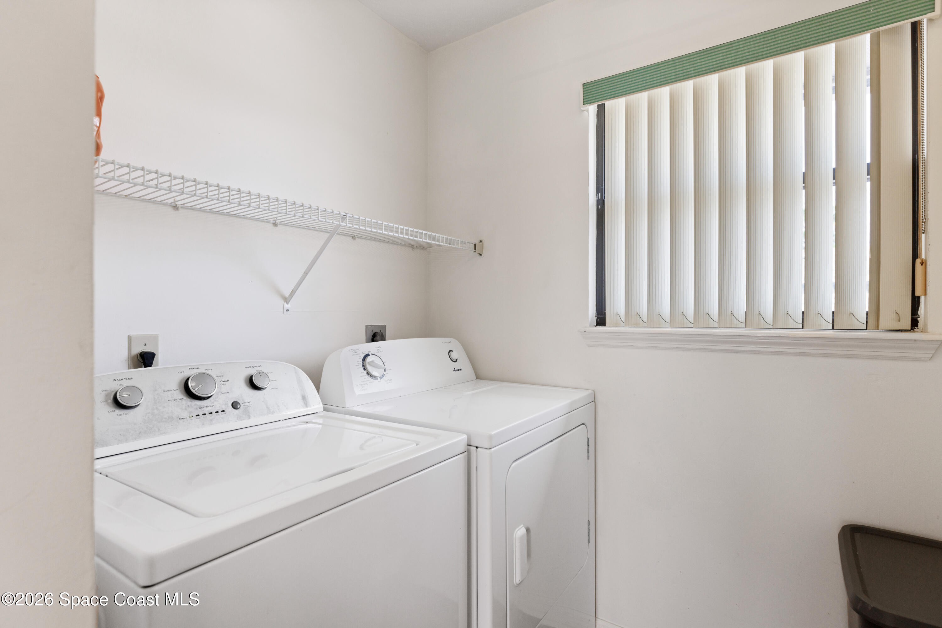 654 Centre Court Southwest, Unit 201 Vero Beach, FL 32962 - Photo 16 of 20 a utility room with dryer and washer