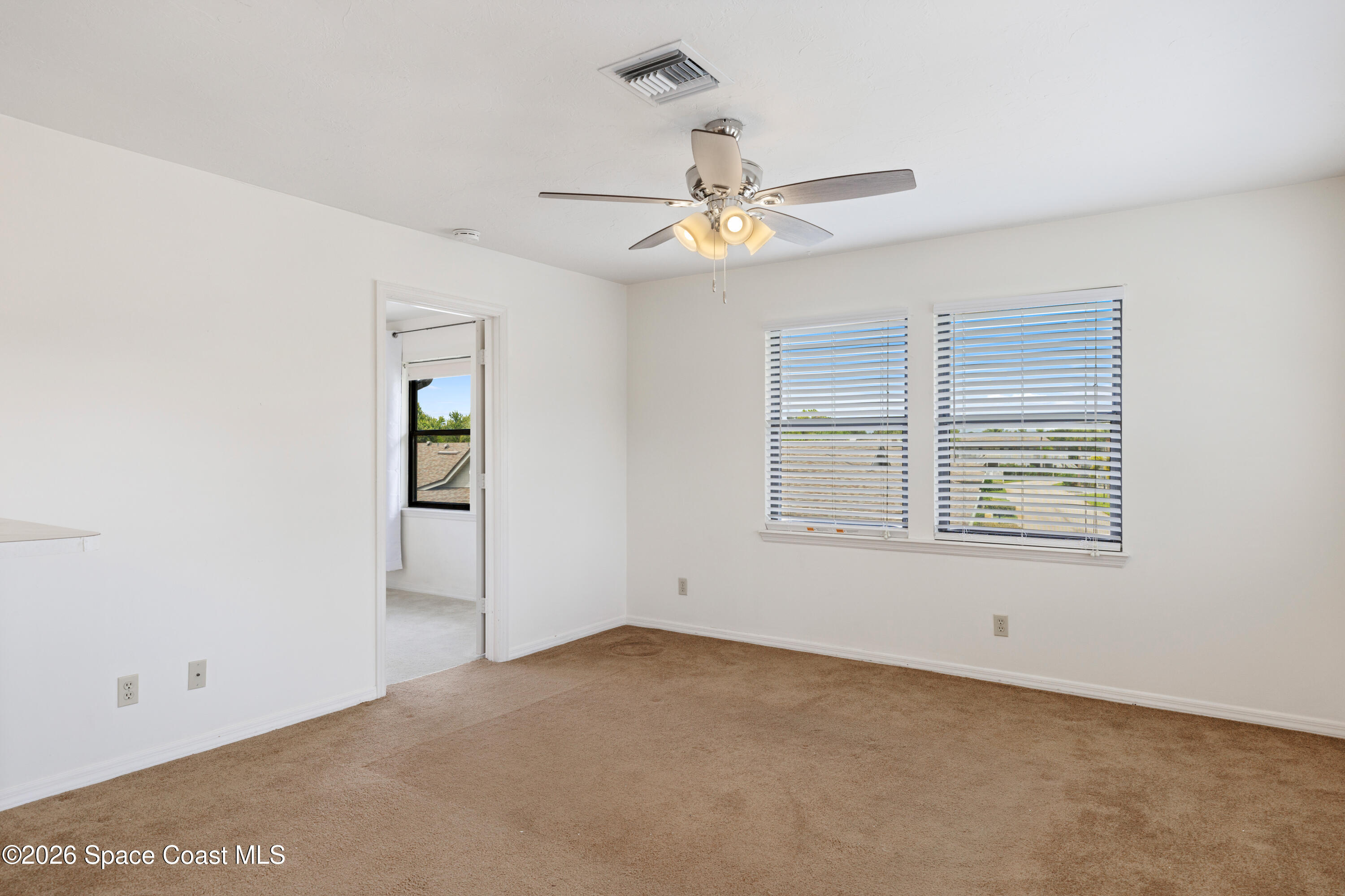 654 Centre Court Southwest, Unit 201 Vero Beach, FL 32962 - Photo 17 of 20 a view of an empty room with a window