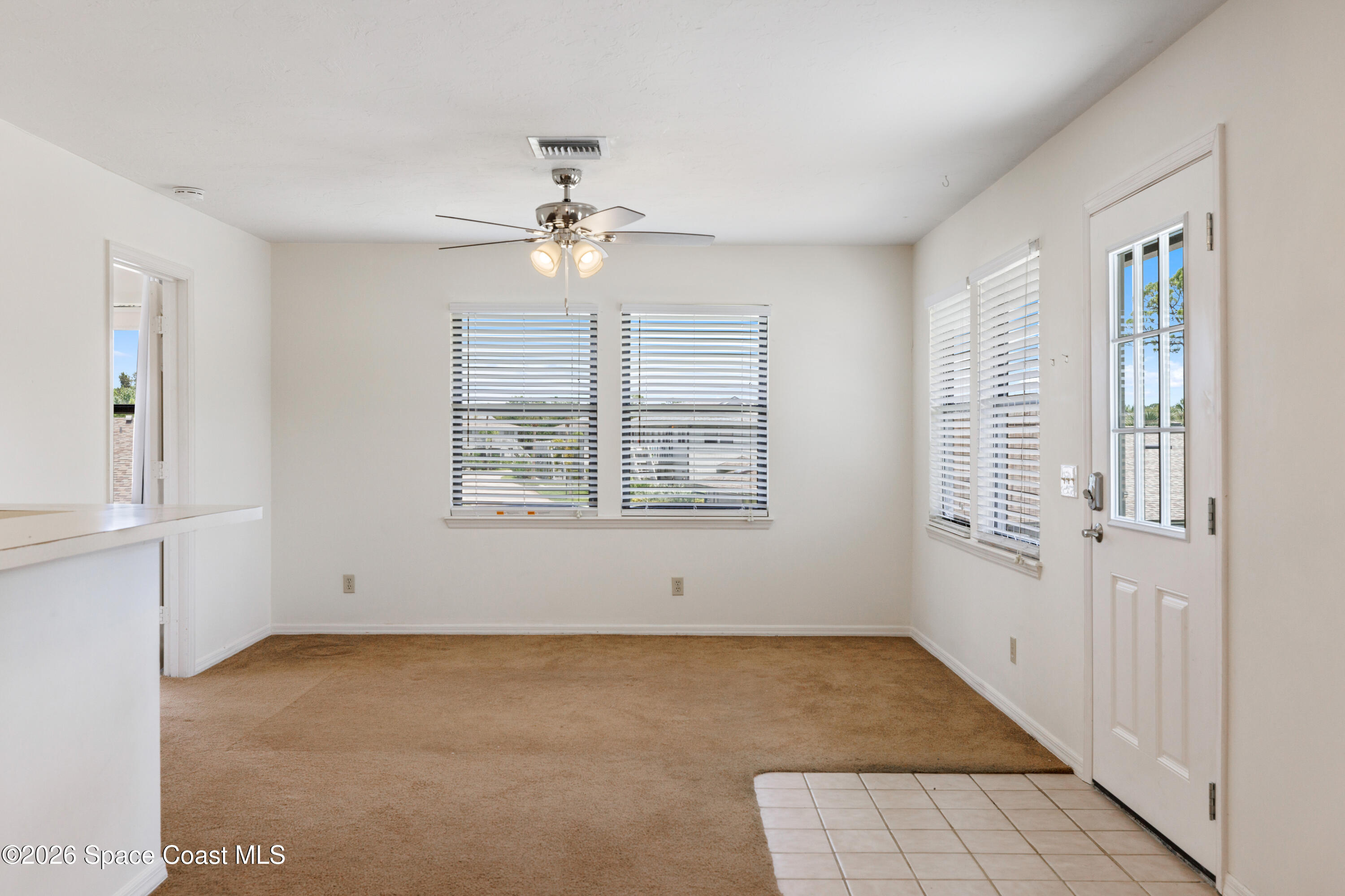654 Centre Court Southwest, Unit 201 Vero Beach, FL 32962 - Photo 5 of 20 a view of an empty room with a window