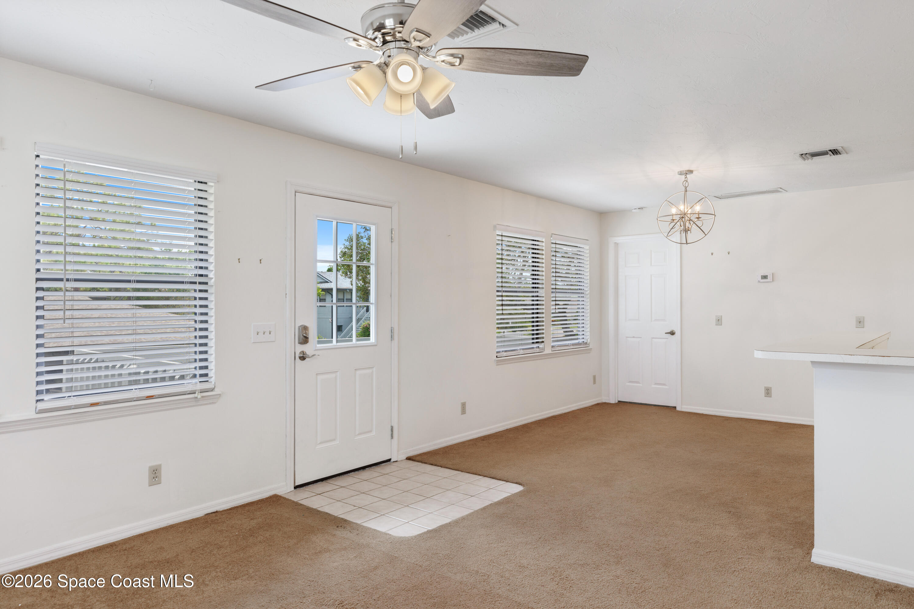 654 Centre Court Southwest, Unit 201 Vero Beach, FL 32962 - Photo 6 of 20 a view of an empty room with a window