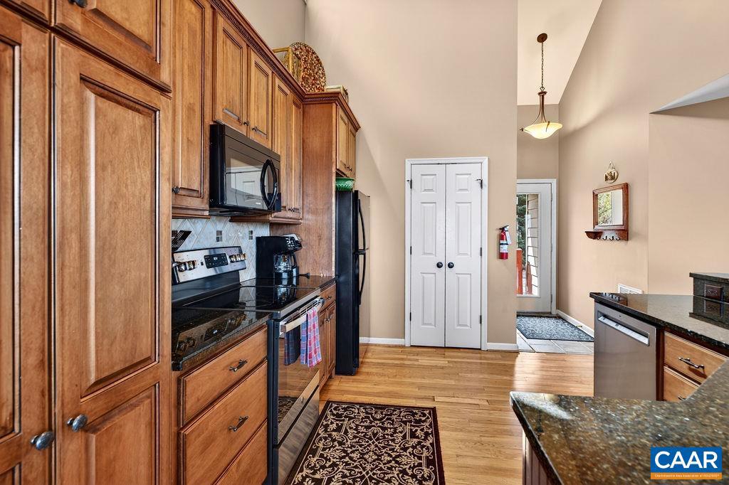 42 Peavy Point Wintergreen, VA 22967 - Photo 14 of 74 a kitchen with stainless steel appliances granite countertop a refrigerator a stove and a sink with wooden floor