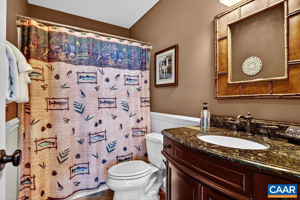 42 Peavy Point Wintergreen, VA 22967 - Photo 24 of 74 a bathroom with a granite countertop sink and a mirror