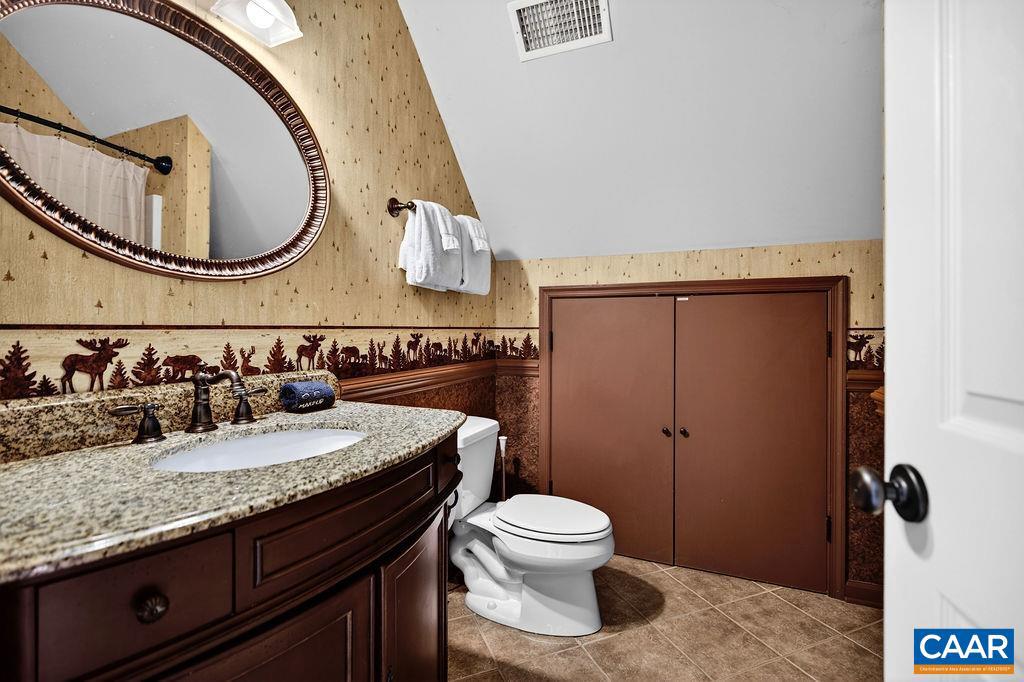 42 Peavy Point Wintergreen, VA 22967 - Photo 40 of 74 a bathroom with a granite countertop toilet sink and mirror