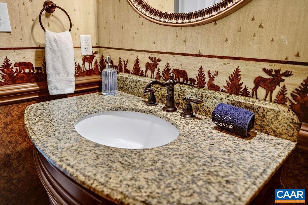 42 Peavy Point Wintergreen, VA 22967 - Photo 42 of 74 a bathroom with a granite countertop sink and a mirror