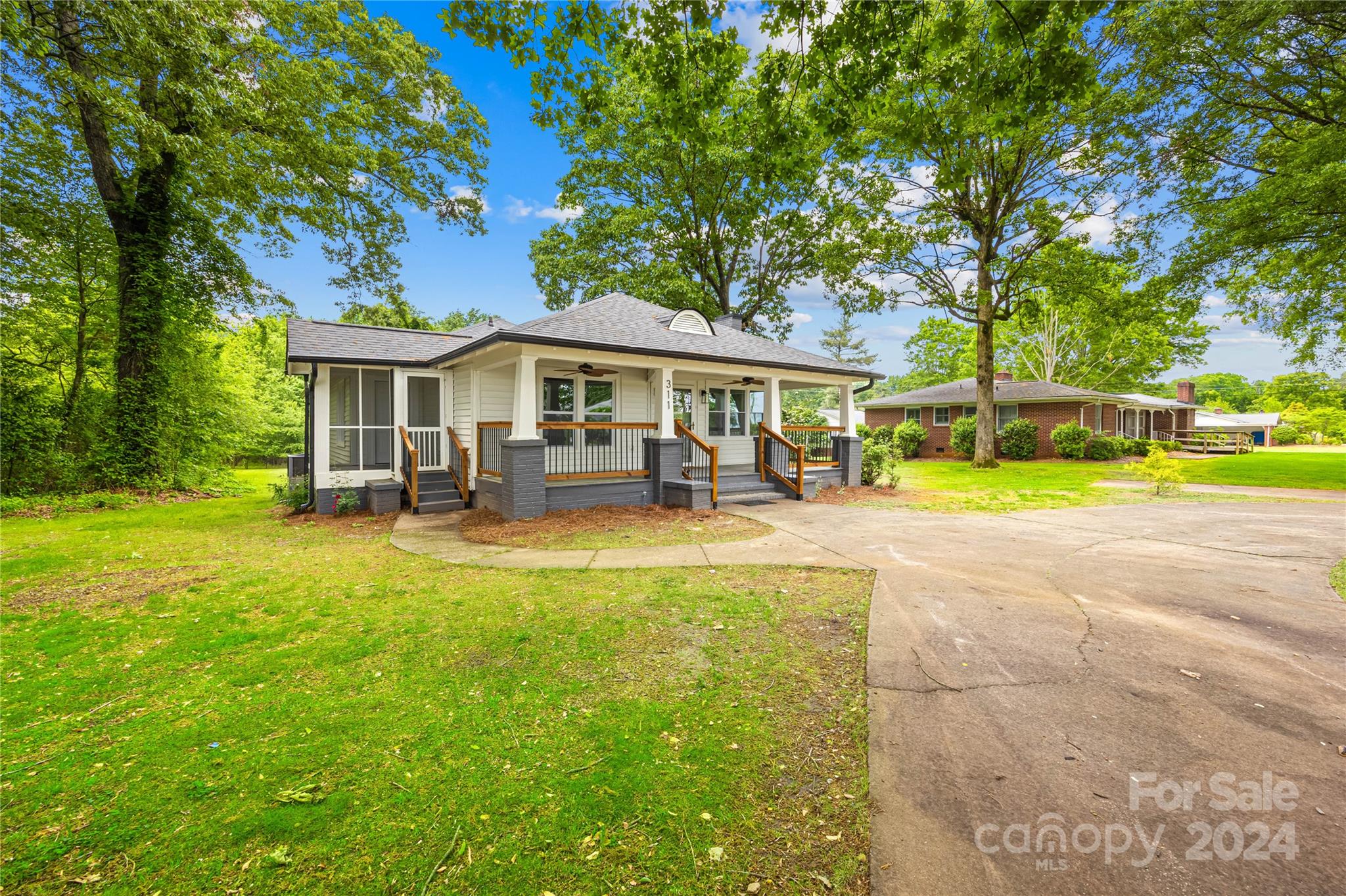 a view of a house with a backyard porch and sitting area
