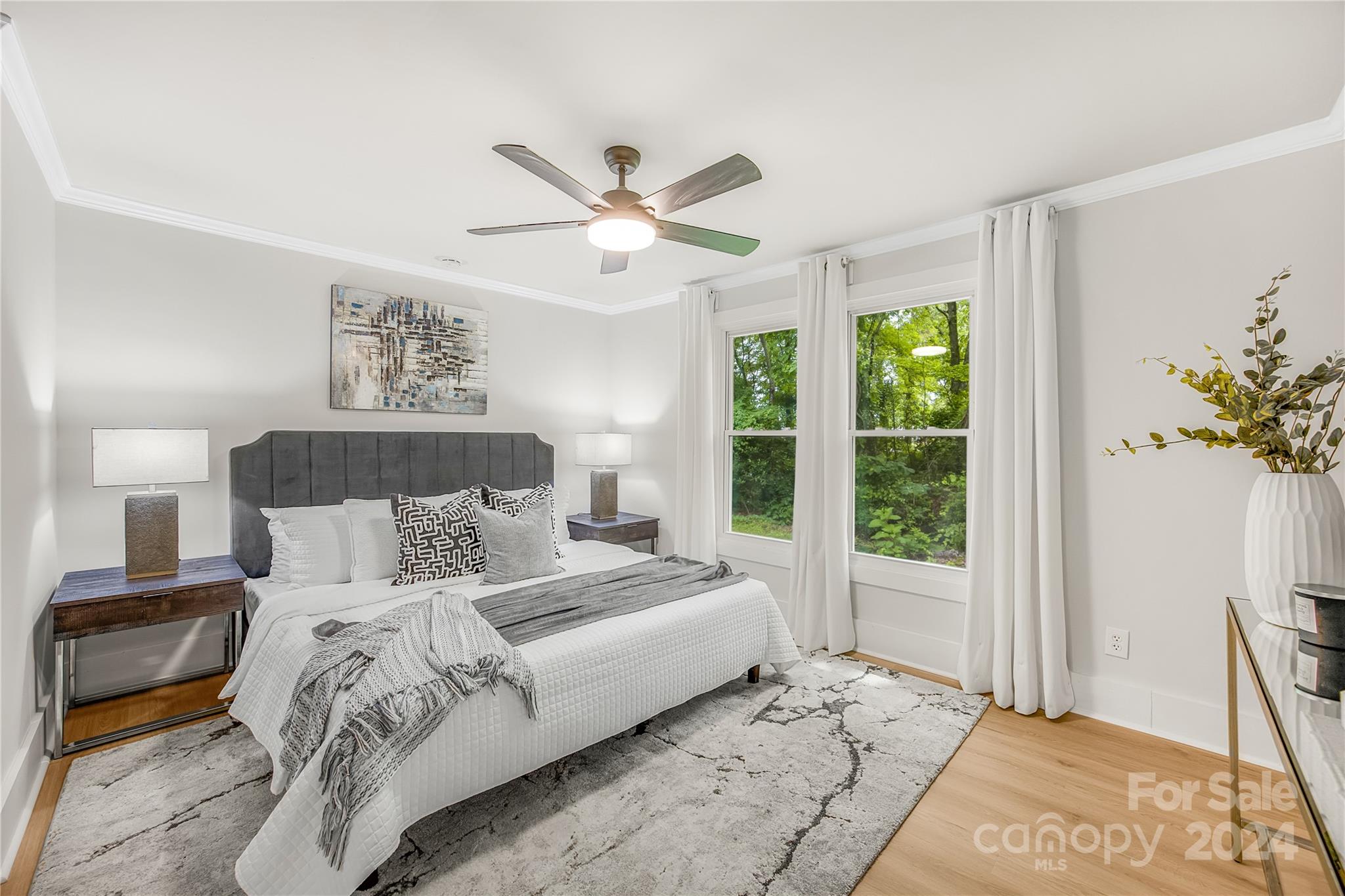 311 Roy Eaker Road Cherryville, NC 28021 - Photo 13 of 23 a bedroom with a large bed and a chandelier