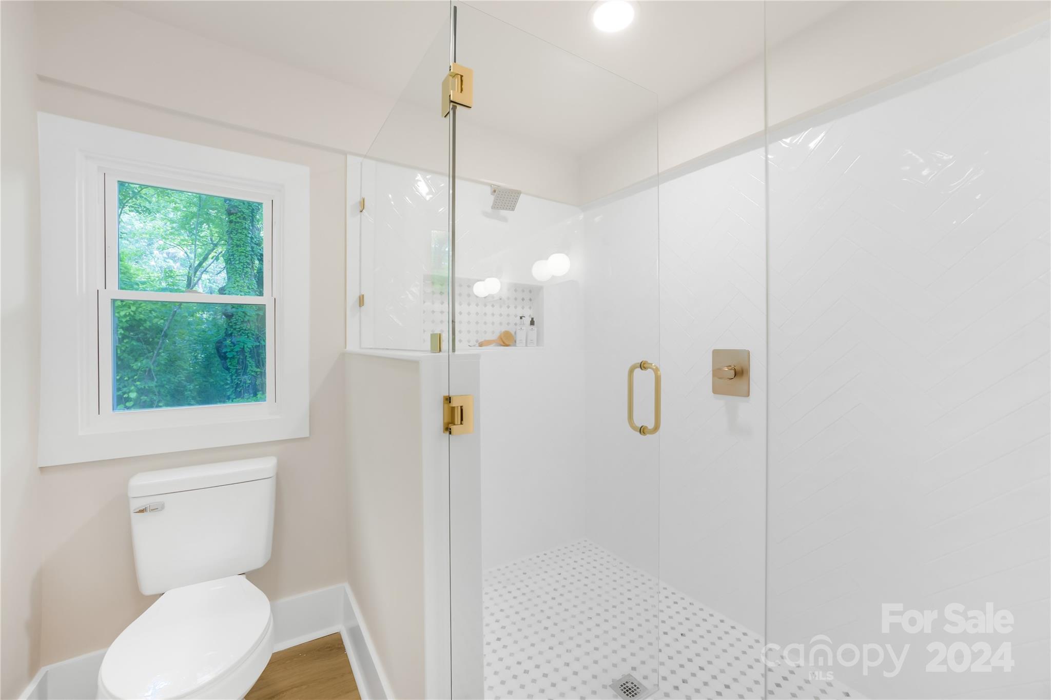 311 Roy Eaker Road Cherryville, NC 28021 - Photo 16 of 23 a bathroom with a shower a toilet and a window