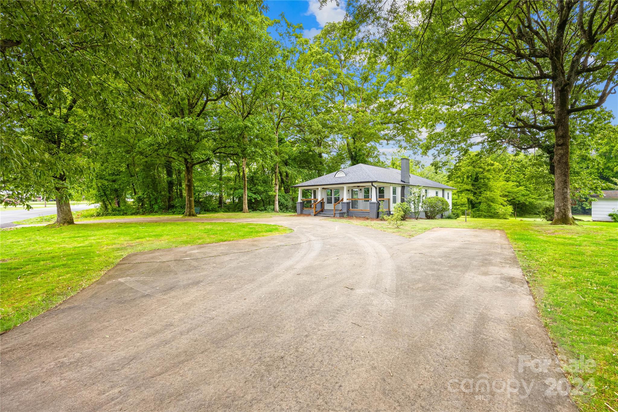 311 Roy Eaker Road Cherryville, NC 28021 - Photo 2 of 23 a house with swimming pool in front of it