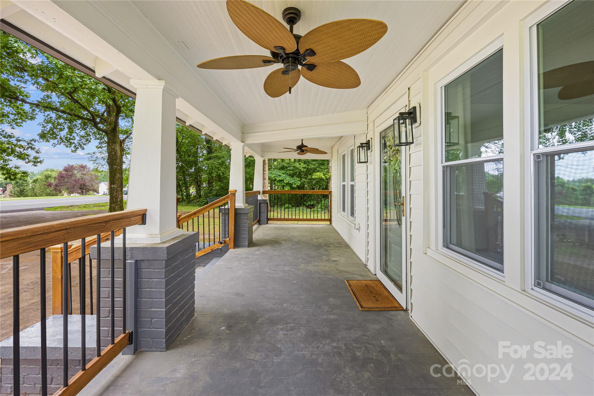 311 Roy Eaker Road Cherryville, NC 28021 - Photo 3 of 23 a view of a porch with wooden floor and a floor to ceiling window